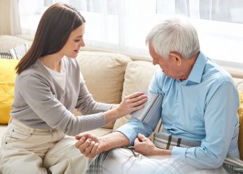 nurse-taking-pressure-of-elderly-man-at-home